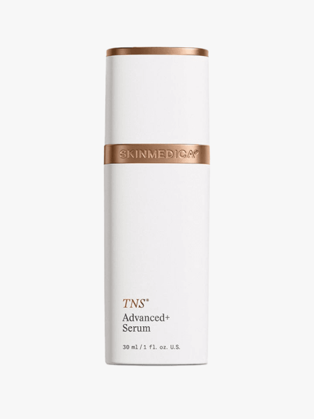 A white bottle of SkinMedica TNS Advanced+ Serum on a light gray background
